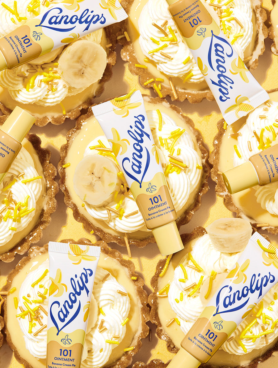 Lifestyle shot of Lanolips 101 Ointment Multi Balm Banana Cream Pie with dessert