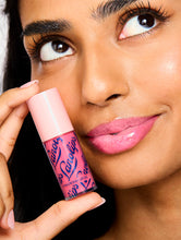 Load image into Gallery viewer, Model holding the Lanolips Hyaluronic Lip Oil in Raspberry
