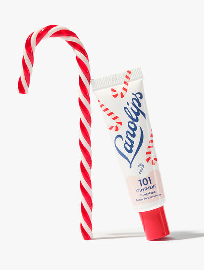 Lanolips 101 Ointment Multi-Balm Candy Cane lip balm leaning candy cane lolly, against a white background.