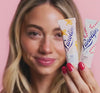 Lanolips holiday video featuring a model dancing and holding the holiday 101 ointment flavoured lip balm in gingerbread and candy cane.