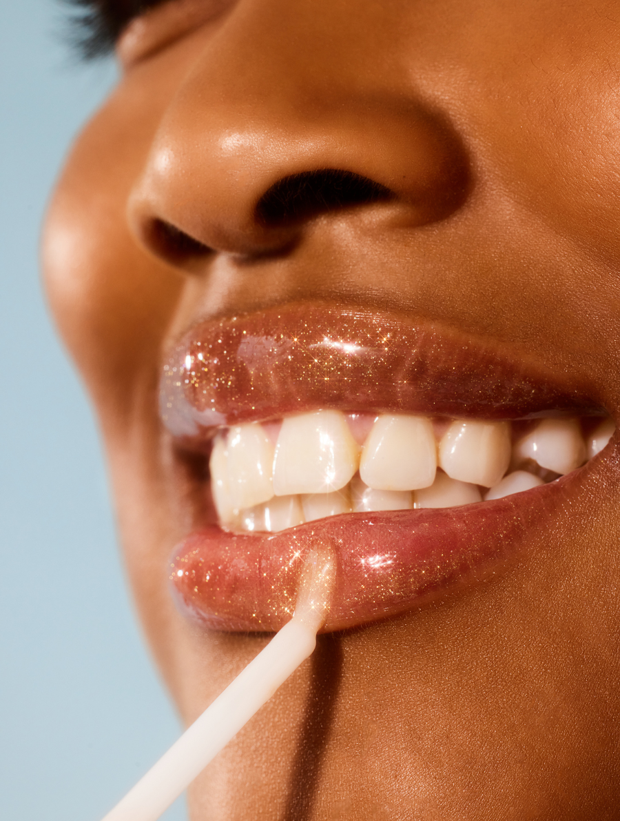 Model applying Lanolips Lip Water Liquid Gold