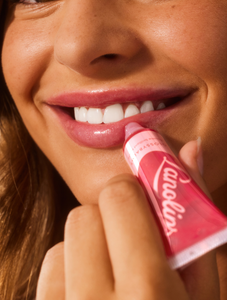 Model applying Lanolips' Glossy Balm Candy