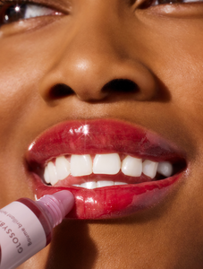 Close up of model wearing Lanolips' Glossy Balm in Berry